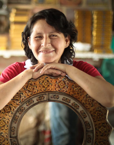 Asunta Pelaez proudly poses with one of her mirrors