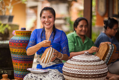 Wayan Sukerni working from home alongside her neighbors.